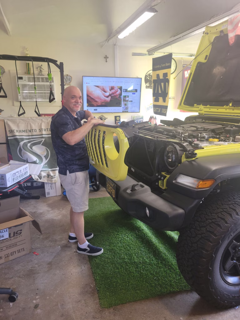 Rob taking off the grill to replace headlights.